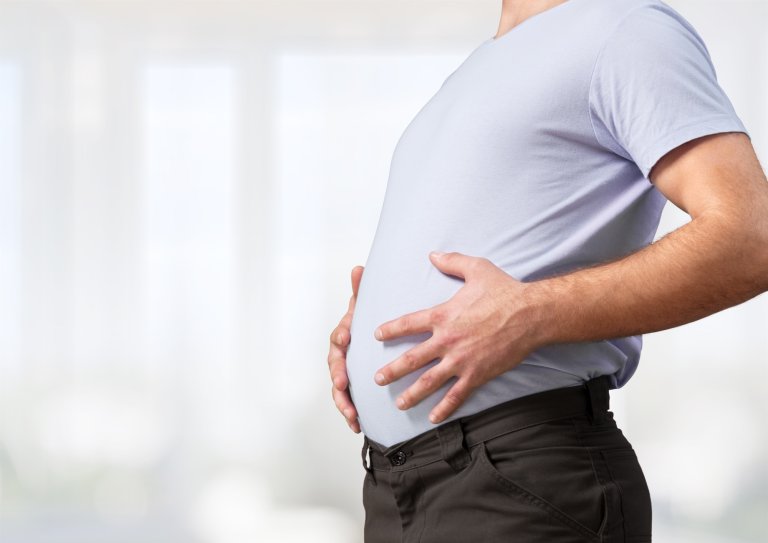 A man holding his belly