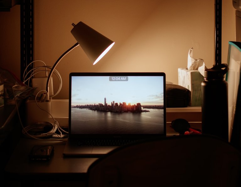 A laptop on a college-dorm desk